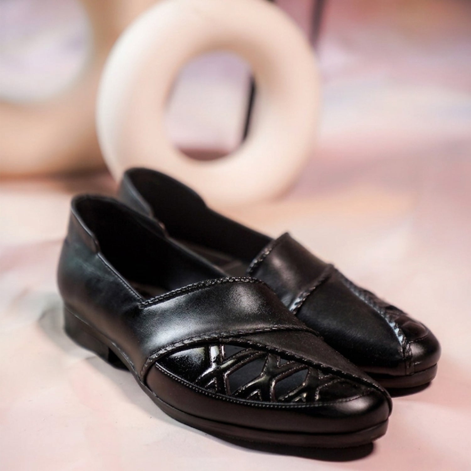 Black leather men’s slip-on loafers with cut-out detailing and polished finish