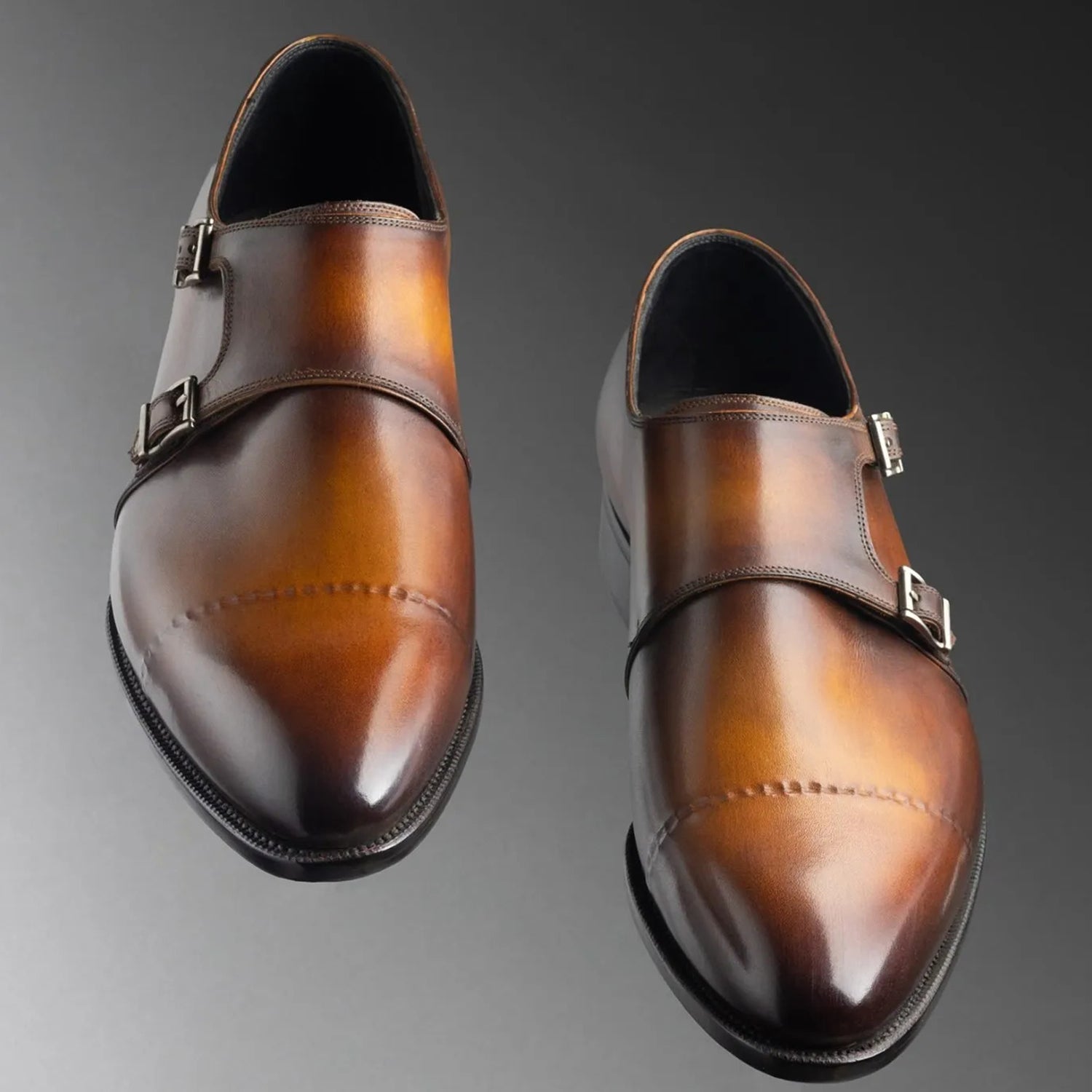 Luxury men's caramel brown patina genuine leather double monk strap formal dress shoes featuring a cap-toe design, polished silver double buckle closure, hand-painted leather finish, cushioned footbed, breathable leather lining, and premium craftsmanship for weddings, office wear, business meetings, and formal occasions.