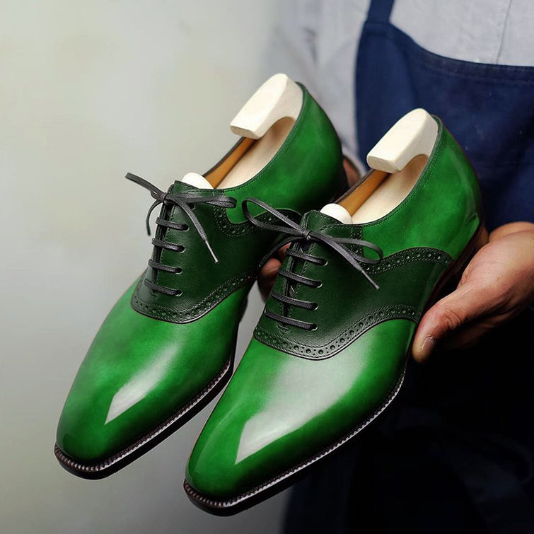 Handmade green leather Oxford dress shoes for men with wingtip detailing, lace-up closure, and luxury hand-painted patina finish.