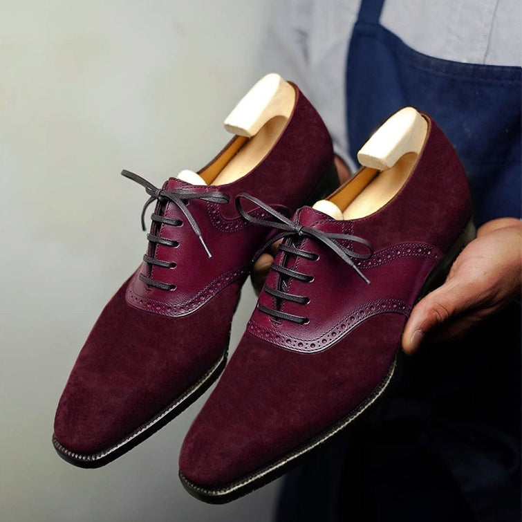 Premium burgundy suede Oxford brogue dress shoes for men featuring genuine leather wingtip detailing, closed-lace construction, elegant craftsmanship, and wooden shoe trees for maintaining shape.