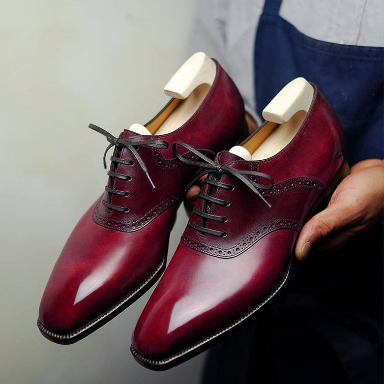 Premium men's burgundy leather Derby shoes with polished finish, elegant brogue detailing, classic lace-up closure, refined cap-toe design, and sophisticated formal styling for office wear, weddings, business meetings, and special occasions.
