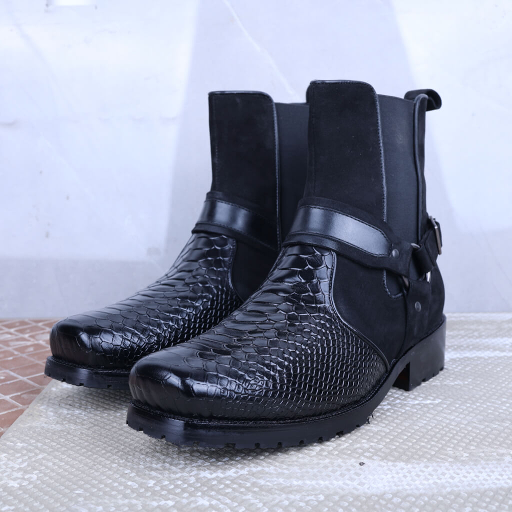 Luxury black leather ankle-high boots with a croc-embossed design, featuring a durable rubber sole for added grip, a secure side zipper, and elegant leather detailing. Ideal for both casual and formal wear, offering style, comfort, and sophistication.

