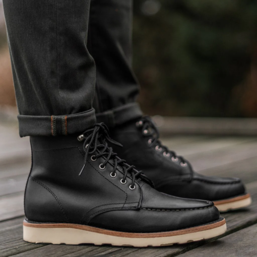 Onyx Ridge Moc Toe Black Leather Boots with hand-stitched moccasin toe, premium black leather, Vibram sole for grip, cork midsole for custom fit, metallic eyelets, and robust laces.

