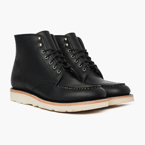 Onyx Ridge Moc Toe Black Leather Boots with hand-stitched moccasin toe, premium black leather, Vibram sole for grip, cork midsole for custom fit, metallic eyelets, and robust laces.
