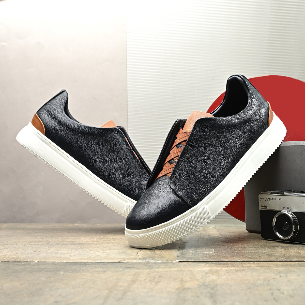 Men's black Italian imported calf leather sneakers with tan-brown laces, memory foam cushioning, and off-white rubber sole