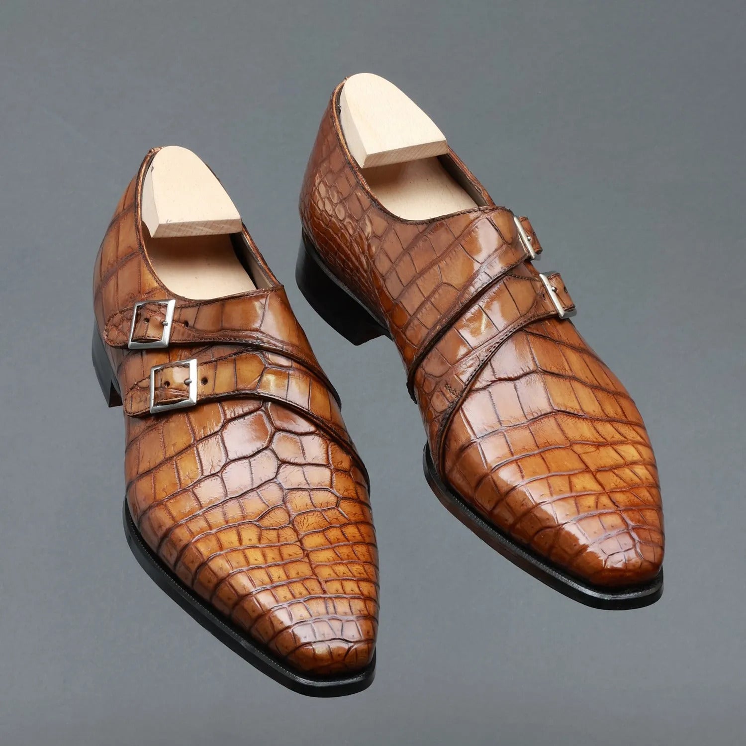 Luxury men's tan crocodile embossed genuine leather double monk strap formal dress shoes featuring polished silver buckles, almond toe design, glossy hand-finished leather, cushioned footbed, and premium craftsmanship for weddings, office wear, business meetings, and formal occasions.