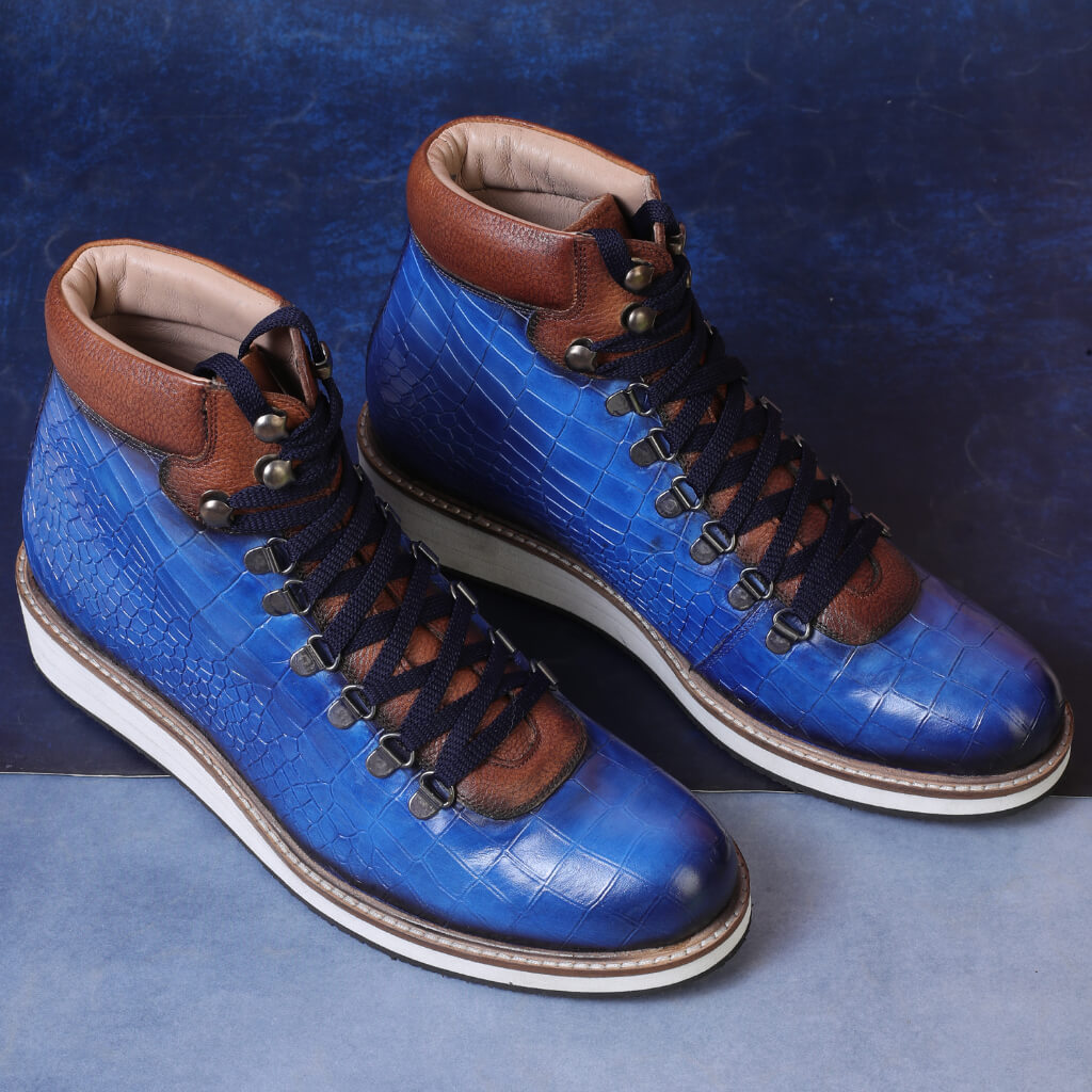 "Striking blue Noa textured hiker-style lace-up boots with a croco-textured upper, lightweight EVA sole for cushioning, and a secure fit for comfort and stability."

