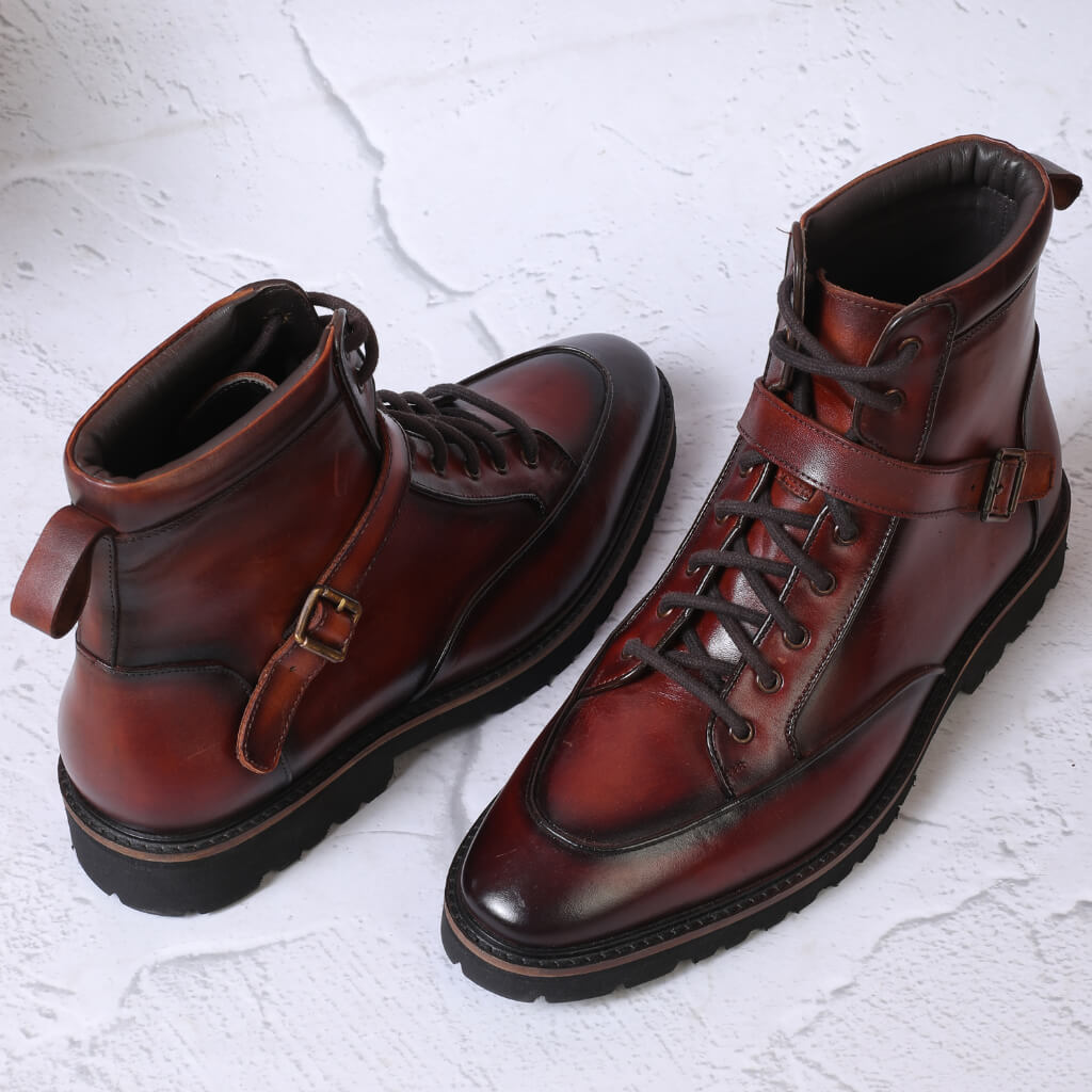 "Hand-painted brown leather Mille Dollari boots with an ultra-lightweight sole, ankle-length fit, and versatile style for travel and all-day comfort."

