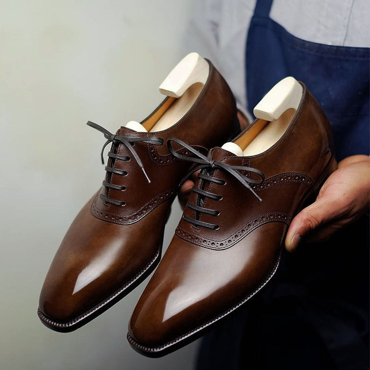 Premium men's brown leather Derby shoes featuring elegant brogue detailing, polished finish, classic lace-up closure, refined cap-toe design, and sophisticated formal styling for office wear, weddings, business meetings, and special occasions.