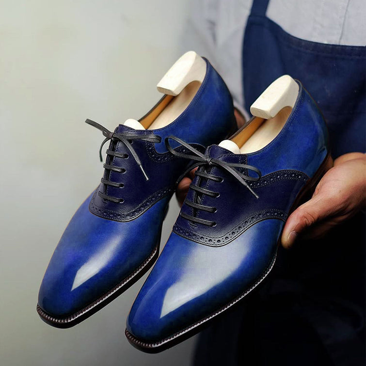 Handmade blue leather Oxford dress shoes for men featuring a hand-painted patina finish, wingtip detailing, closed-lace design, and premium formal craftsmanship.